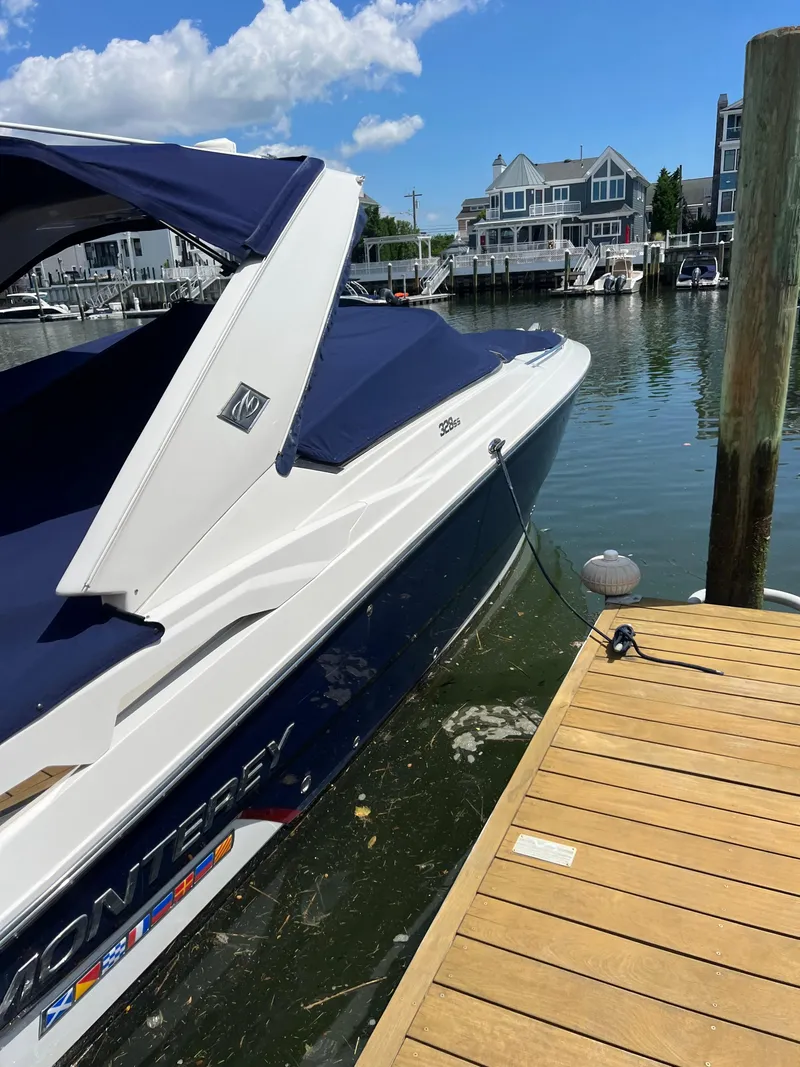 Slide: The Image of 2018 Monterey 328 Super Sport boat docked at a marina on a sunny day. - 8