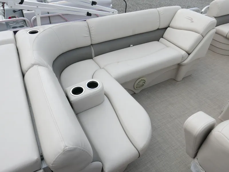 Slide: The Image of 2016 Bennington 208SL boat interior with plush seating and cup holders. - 10