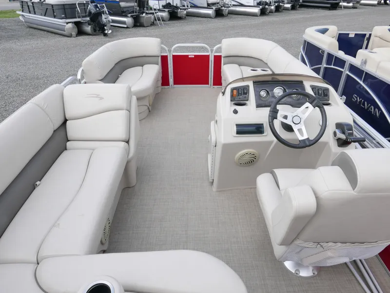 Slide: The Image of 2016 Bennington 208SL pontoon boat interior with beige seating and steering console. - 12