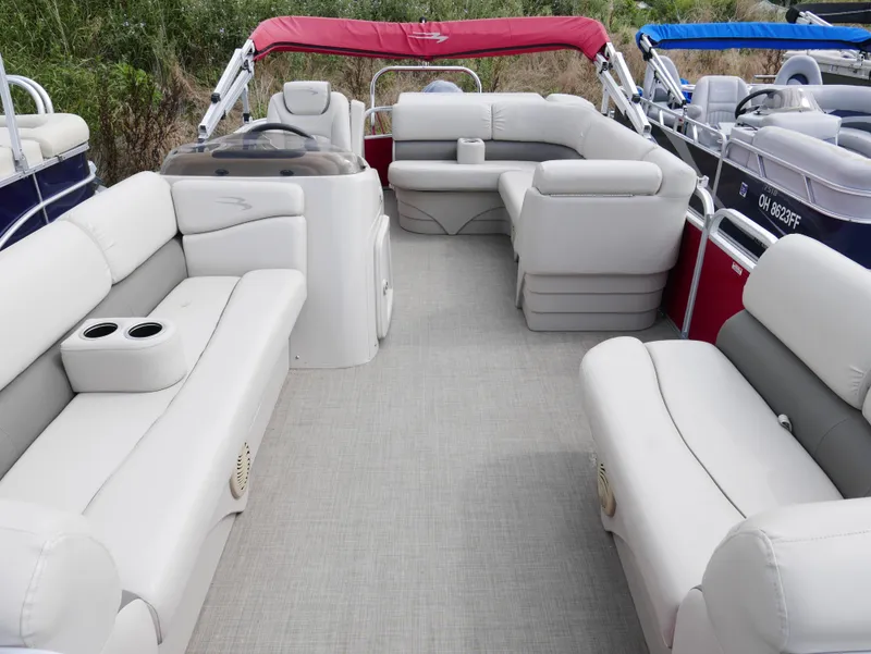 Slide: The Image of 2016 Bennington 208SL pontoon boat with spacious seating and red canopy. - 4