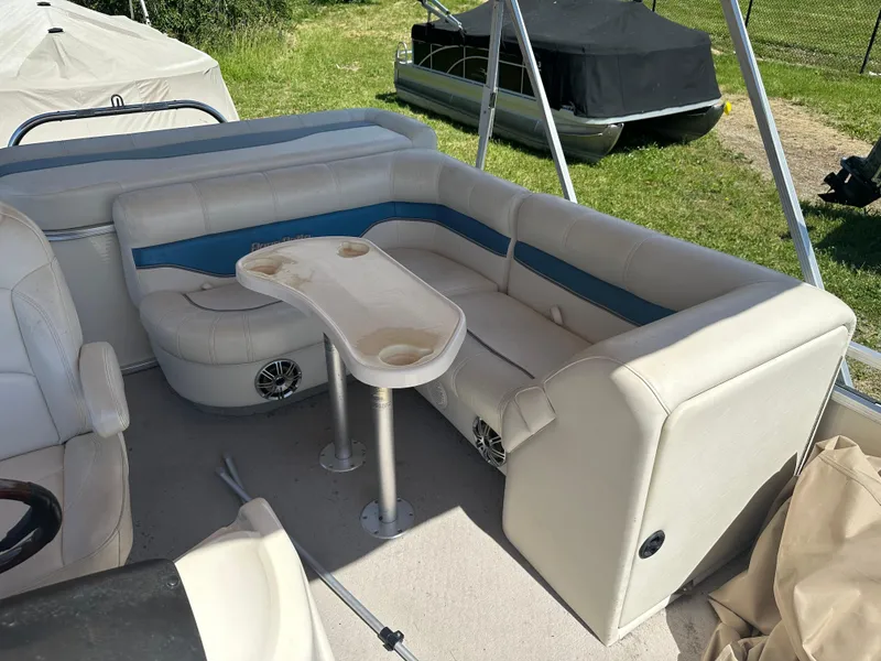 Slide: The Image of 2006 Godfrey Aqua Patio 200 RE boat interior with seating and table. - 8