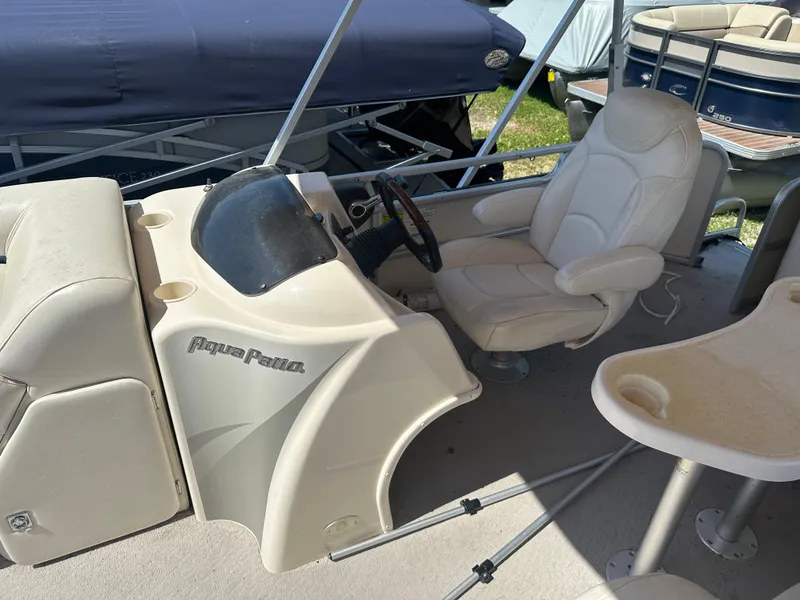 Slide: The Image of 2006 Godfrey Aqua Patio 200 RE boat interior with captain's chair and console. - 9