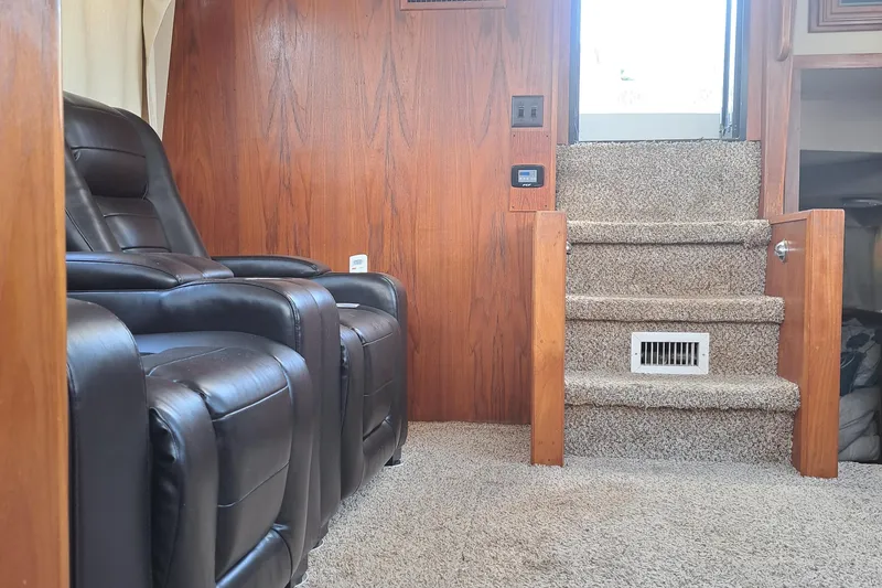 Slide: The Image of Interior of 1989 Carver 3807 with leather recliners and carpeted stairs. - 11