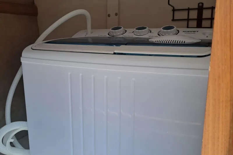 Slide: The Image of Compact washing machine inside a 1989 Carver 3807 boat. - 14