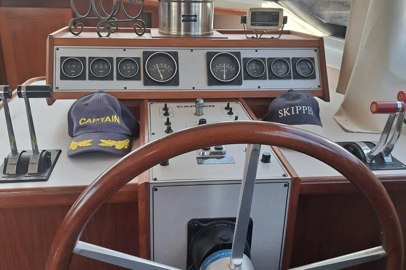 Slide: The Image of 1989 Carver 3807 boat helm with captain and skipper hats. - 17