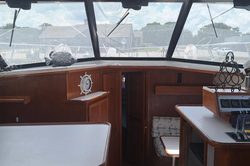 Slide: The Image of Interior of 1989 Carver 3807 yacht with wooden cabinetry and large windows. - 23