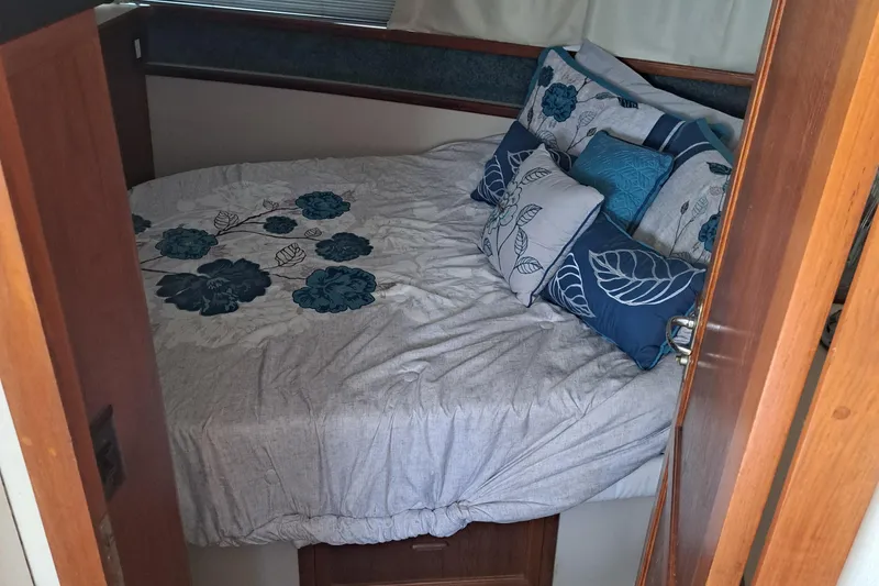 Slide: The Image of 1989 Carver 3807 bedroom with floral bedding and decorative pillows. - 24