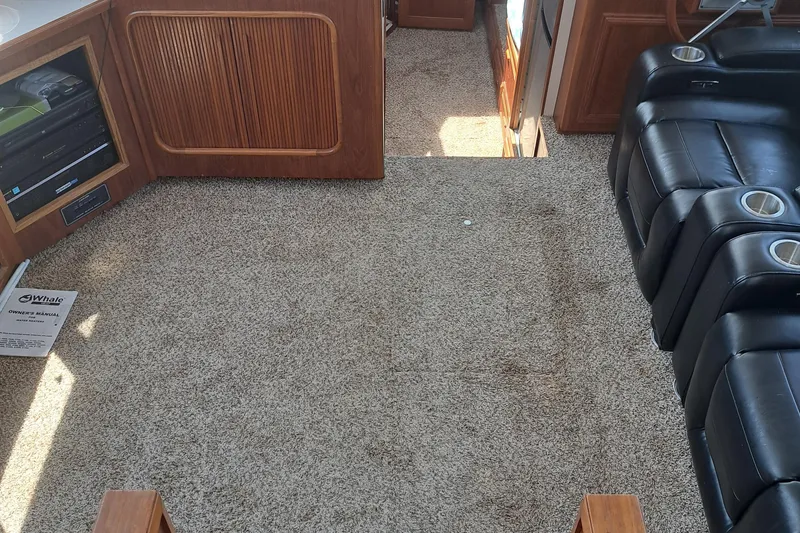 Slide: The Image of Interior of 1989 Carver 3807 yacht with carpet flooring and leather seating. - 27