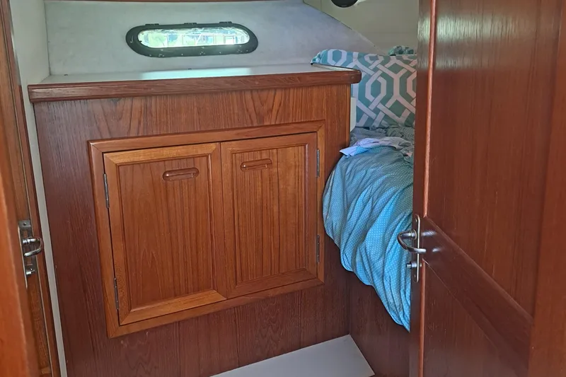 Slide: The Image of Interior cabin of 1989 Carver 3807 yacht with wooden cabinetry and bed. - 29