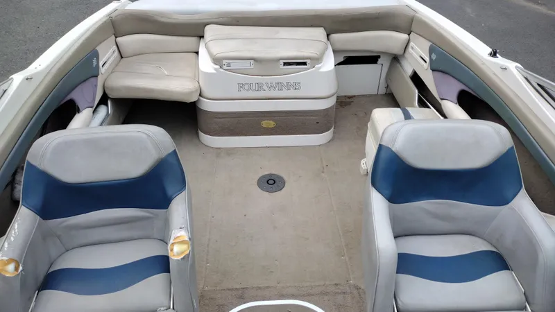 Slide: The Image of 1999 Four Winns 200 Horizon boat interior with seating and storage compartments. - 12