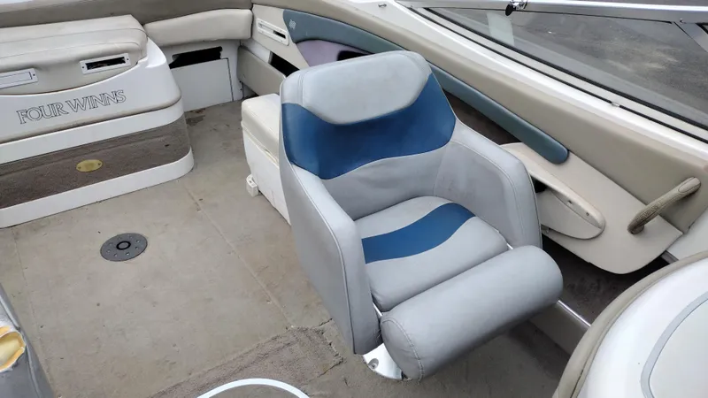Slide: The Image of 1999 Four Winns 200 Horizon boat interior with seating and dashboard. - 13