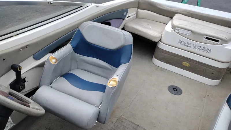 Slide: The Image of 1999 Four Winns 200 Horizon boat interior with captain's chair and seating area. - 14
