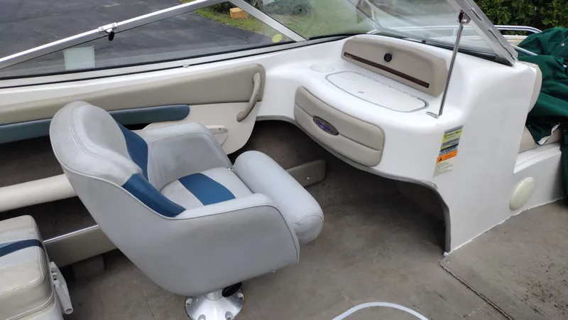 Slide: The Image of 1999 Four Winns 200 Horizon boat interior with captain's chair and dashboard. - 16