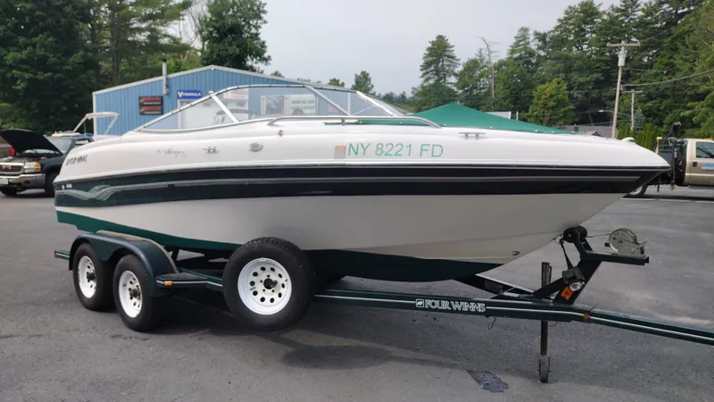 Slide: The Image of 1999 Four Winns 200 Horizon boat on a trailer in a parking lot. - 3
