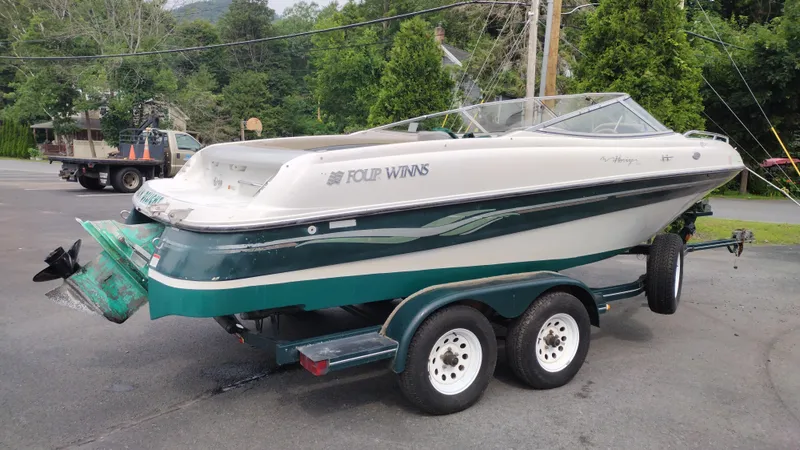 Slide: The Image of 1999 Four Winns 200 Horizon boat on a trailer, green and white exterior. - 5