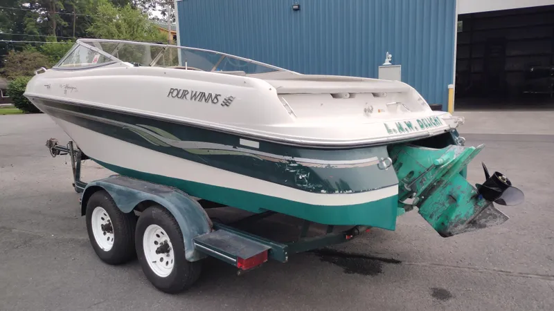 Slide: The Image of 1999 Four Winns 200 Horizon boat on a dual-axle trailer. - 7