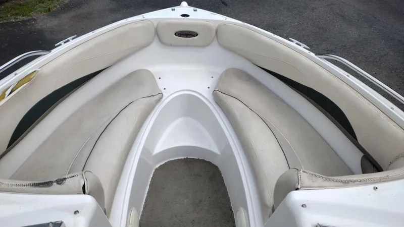 Slide: The Image of 1999 Four Winns 200 Horizon boat bow seating area with white upholstery. - 8