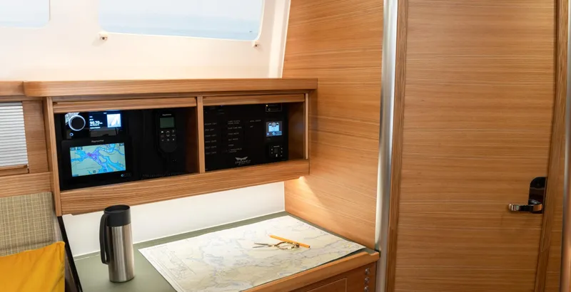 Slide: The Image of Navigation station inside a 2026 Dragonfly 40 yacht with map and control panels. - 12