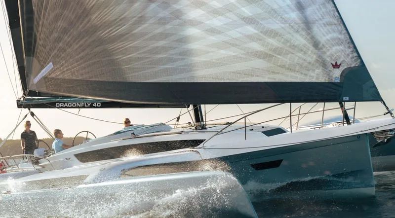 Slide: The Image of 2026 Dragonfly 40 sailboat gliding on water with crew onboard. - 3