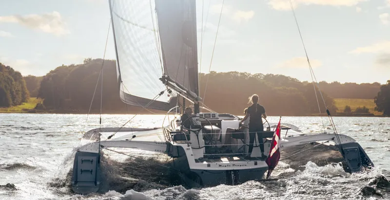 Slide: The Image of Sailing on a Dragonfly 40 trimaran, 2026 model, in a scenic waterway. - 4