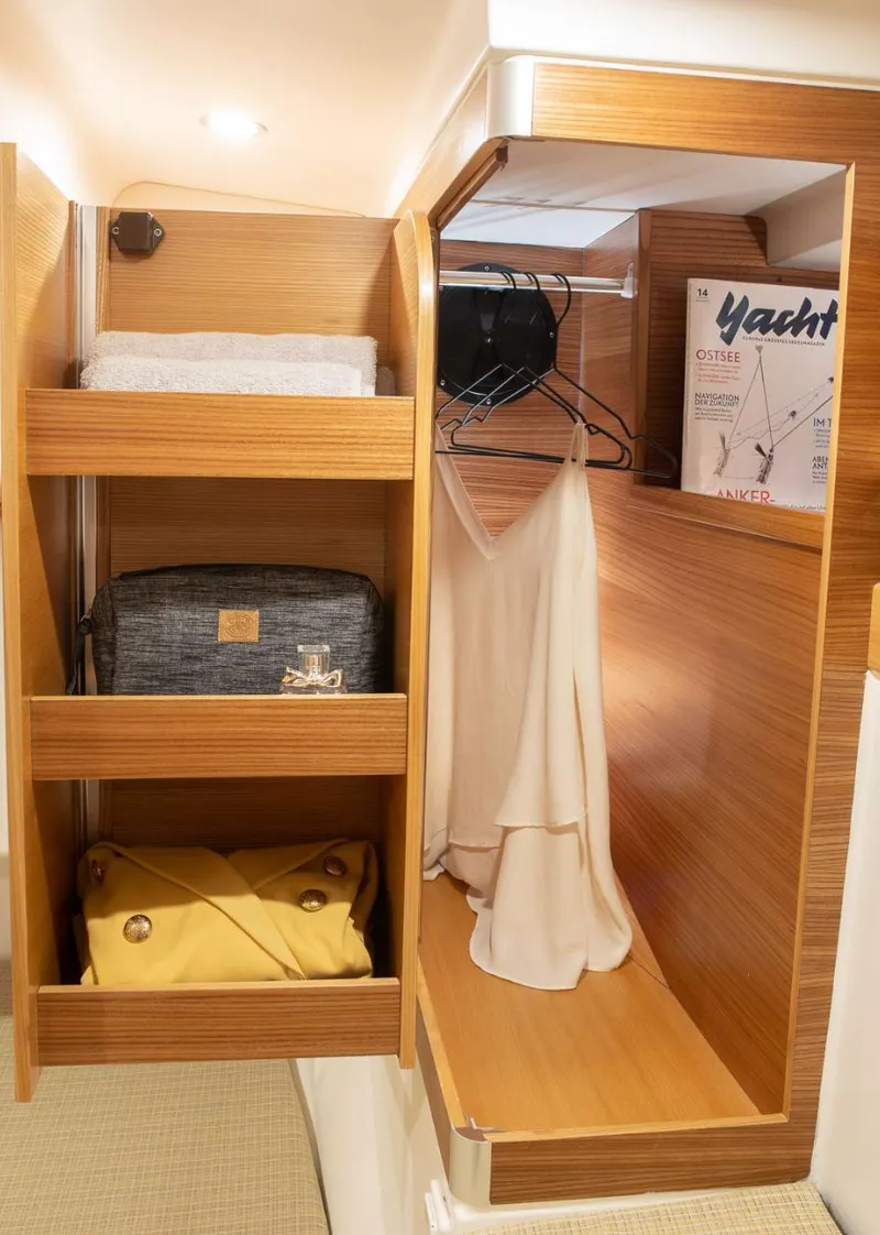 Slide: The Image of Compact wooden closet in Dragonfly 40 yacht, featuring shelves and hanging space, 2026 model. - 13