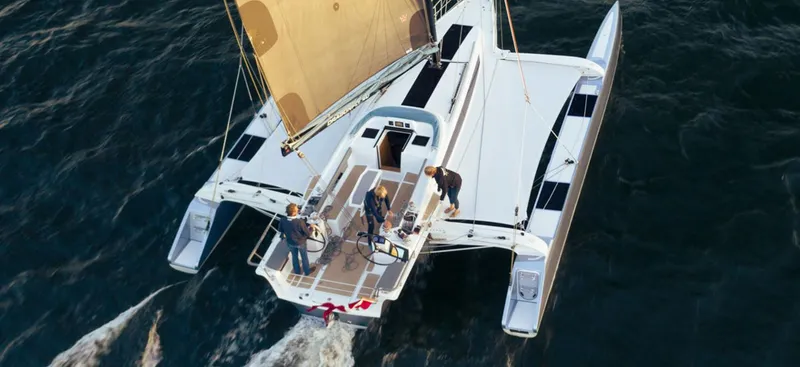 Slide: The Image of 2026 Dragonfly 40 trimaran sailing on open water with crew onboard. - 5