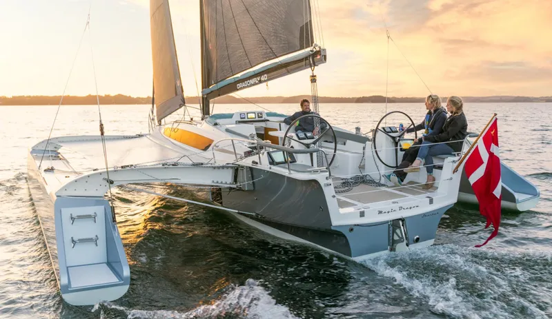 Slide: The Image of Sailing on a Dragonfly 40 trimaran, 2026 model, at sunset with Danish flag. - 6