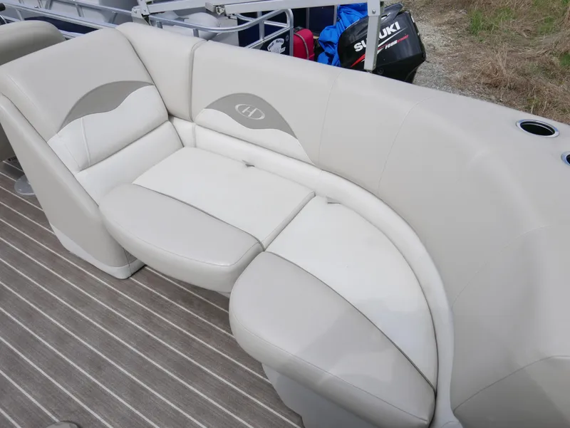 Slide: The Image of 2016 Harris 200 Cruiser boat with beige cushioned seating. - 11