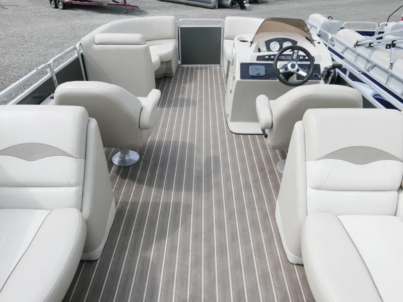 Slide: The Image of 2016 Harris 200 Cruiser boat interior with beige seating and striped flooring. - 12