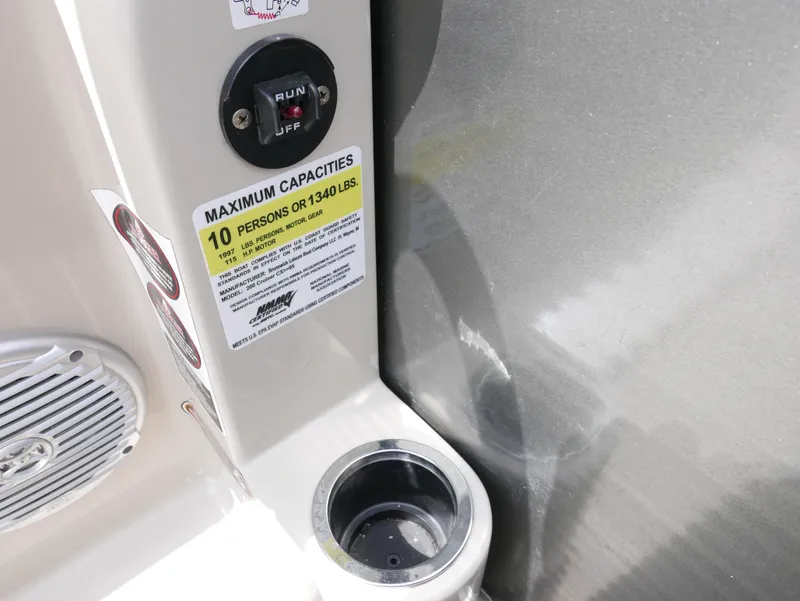 Slide: The Image of 2016 Harris 200 Cruiser boat capacity label and control switch. - 13
