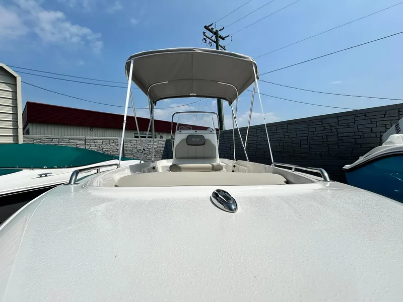 Slide: The Image of 2025 Key West 1720 Center Console boat with canopy in a marina. - 2