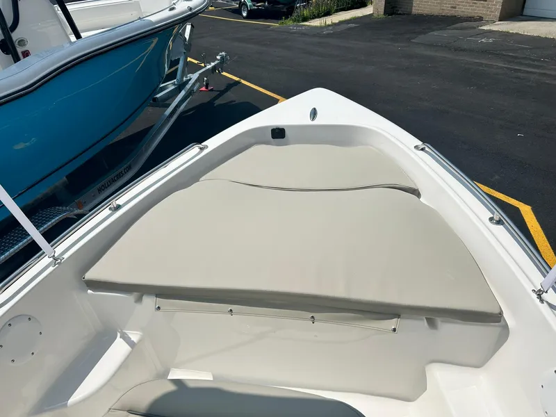 Slide: The Image of 2025 Key West 1720 Center Console boat bow seating area with beige cushions. - 3