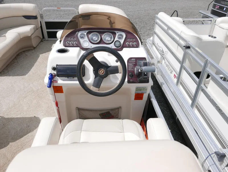 Slide: The Image of 2009 Sylvan Mirage 8520 Cruise boat dashboard and steering wheel. - 10
