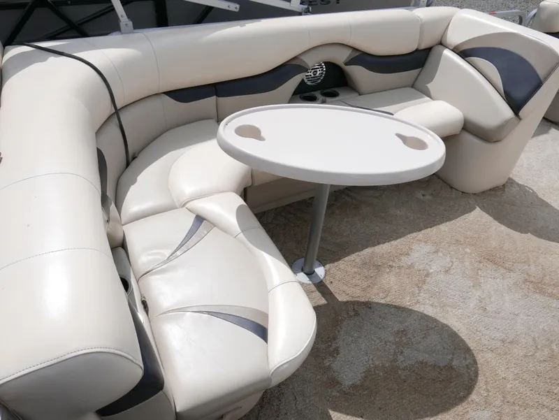 Slide: The Image of 2009 Sylvan Mirage 8520 Cruise boat interior with beige seating and round table. - 11