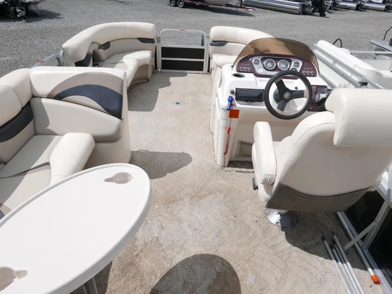 Slide: The Image of 2009 Sylvan Mirage 8520 Cruise pontoon boat interior with plush seating and captain's helm. - 13