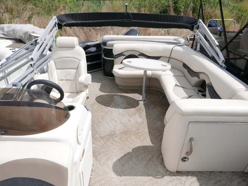 Slide: The Image of 2009 Sylvan Mirage 8520 Cruise pontoon boat interior with seating and table. - 8