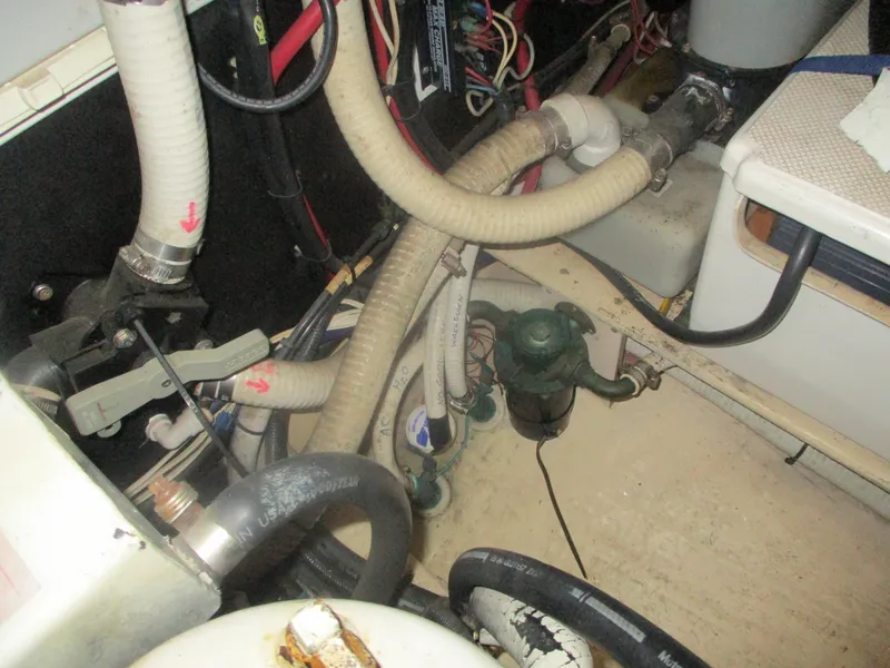 Slide: The Image of Engine room of a 1998 Nordic Tug 32 with visible hoses and wiring. - 25