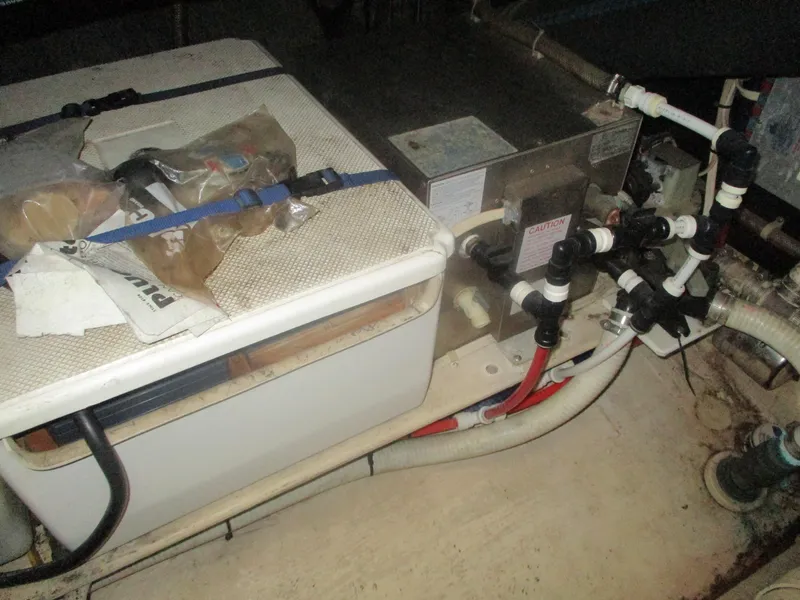 Slide: The Image of Engine room of a 1998 Nordic Tug 32 with visible machinery and piping. - 26