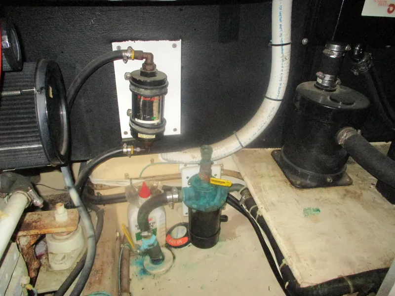 Slide: The Image of Engine room of a 1998 Nordic Tug 32, showing various mechanical components and piping. - 27