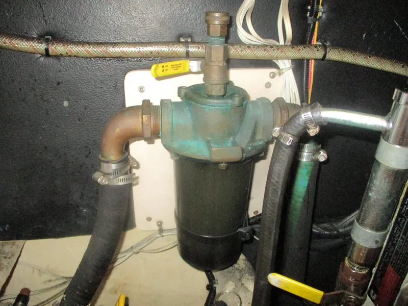 Slide: The Image of Engine compartment of a 1998 Nordic Tug 32, featuring plumbing and filtration system components. - 28