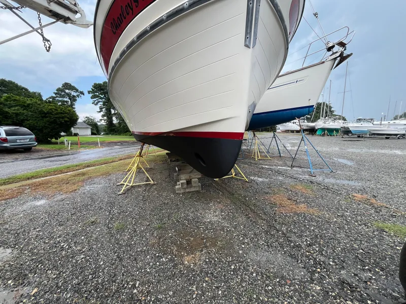 Slide: The Image of 1998 Nordic Tug 32 on dry dock, supported by stands, in a boatyard. - 38