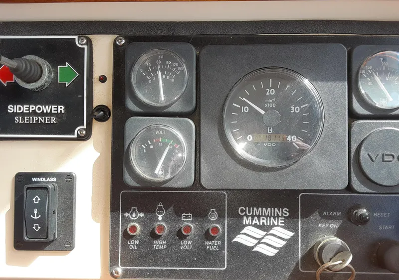Slide: The Image of Control panel of a 1998 Nordic Tug 32 with Cummins Marine gauges and Sidepower controls. - 4