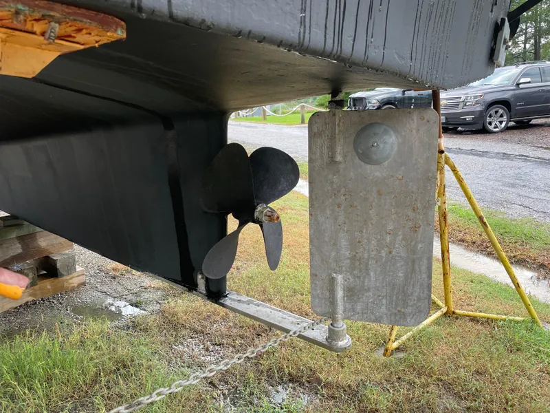 Slide: The Image of 1998 Nordic Tug 32 propeller and rudder detail, displayed on a stand outdoors. - 5