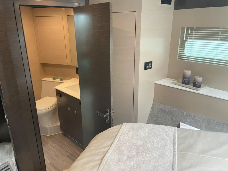 Slide: The Image of 2021 Cruisers Yachts 54 Cantius interior with modern bathroom and cozy bedroom. - 11
