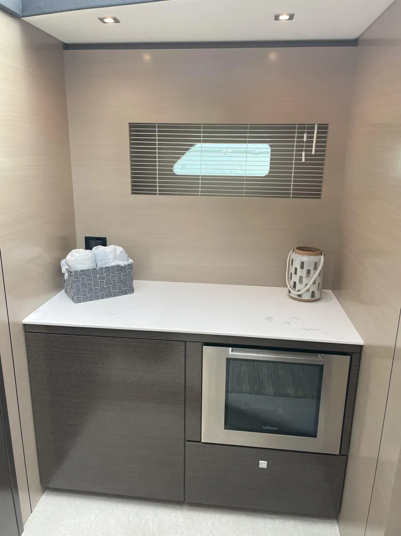 Slide: The Image of Modern kitchen area in 2021 Cruisers Yachts 54 Cantius with sleek cabinetry and oven. - 12