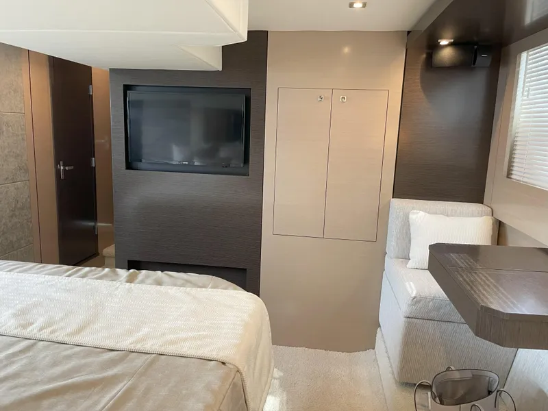 Slide: The Image of 2021 Cruisers Yachts 54 Cantius interior with modern bedroom and TV. - 15