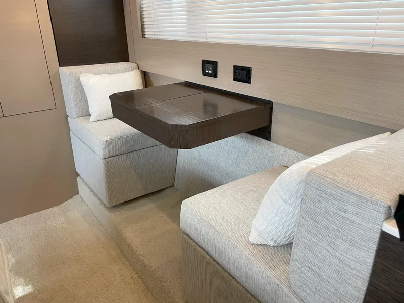 Slide: The Image of Interior seating area of 2021 Cruisers Yachts 54 Cantius with modern design and neutral tones. - 16