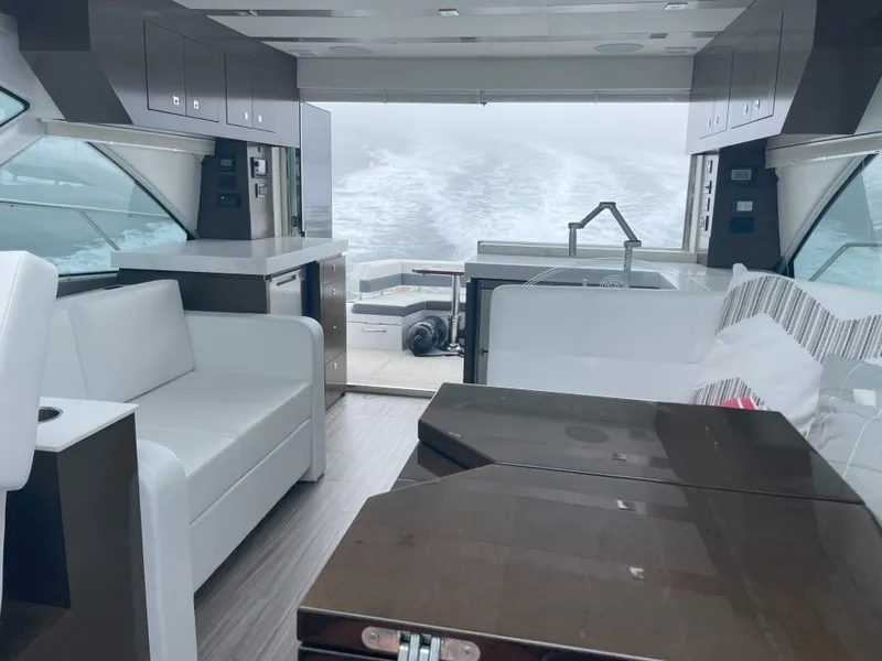 Slide: The Image of Luxurious interior of 2021 Cruisers Yachts 54 Cantius with modern seating and ocean view. - 24