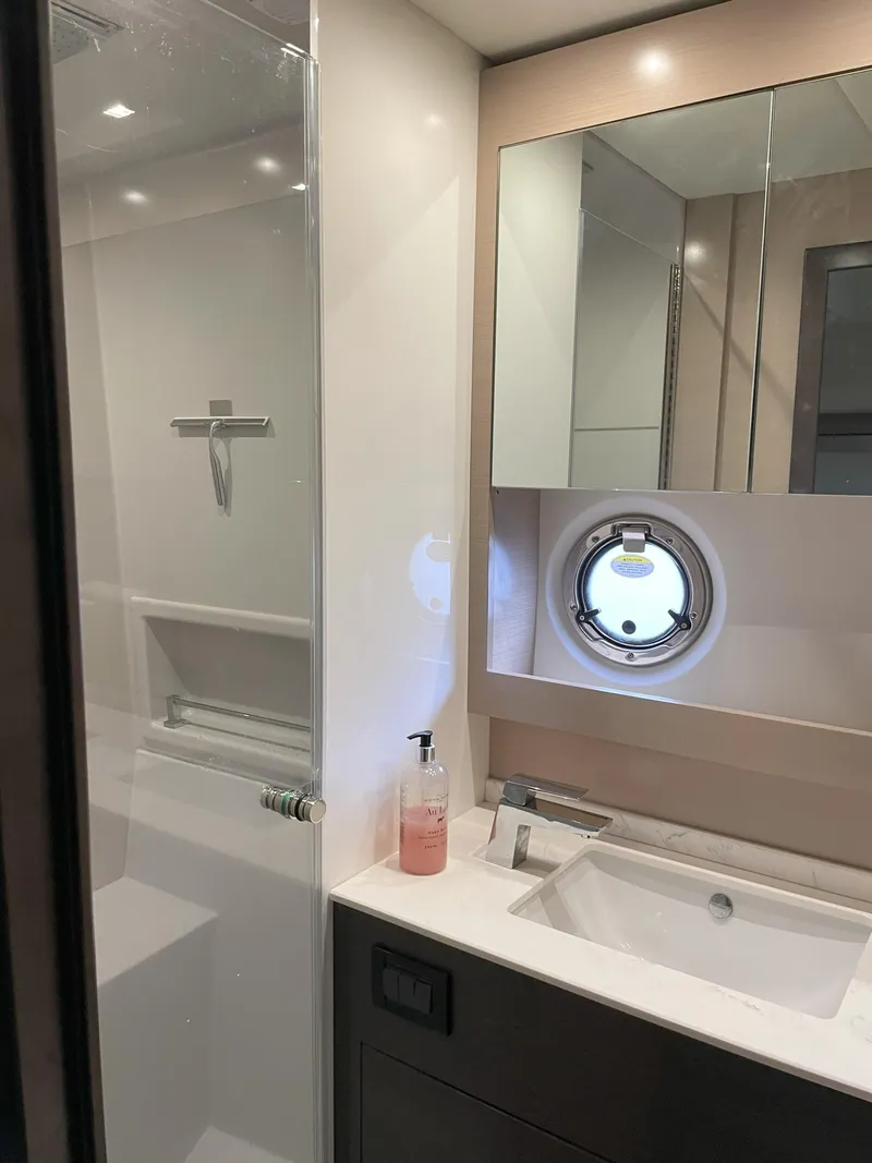 Slide: The Image of Modern bathroom in 2021 Cruisers Yachts 54 Cantius with shower and porthole window. - 27