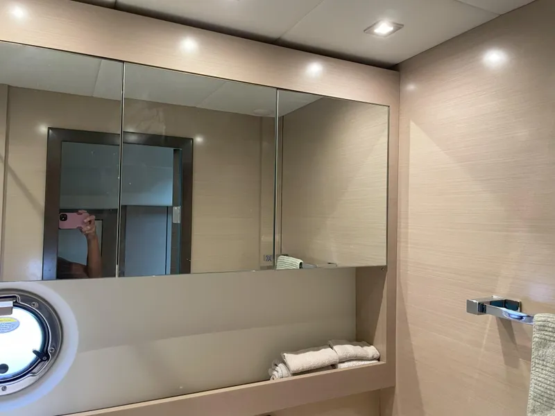 Slide: The Image of Luxurious bathroom interior of 2021 Cruisers Yachts 54 Cantius with mirrored cabinets. - 28